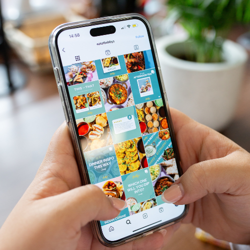 Person scrolling through a restaurant’s Instagram feed featuring branded social media templates and food photos, showcasing effective digital marketing and consistent content creation.